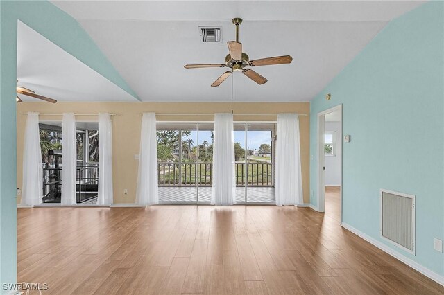 unfurnished room with ceiling fan, vaulted ceiling, and light wood-type flooring