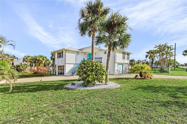 exterior space with driveway and a front lawn