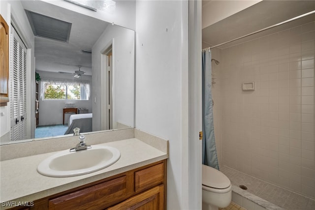 bathroom featuring vanity, toilet, ceiling fan, and curtained shower