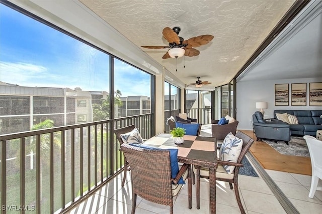 sunroom / solarium with a ceiling fan