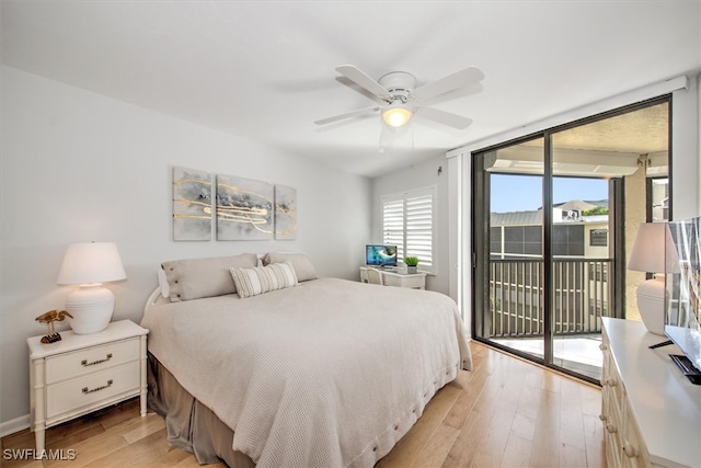 bedroom with access to exterior, light wood-type flooring, expansive windows, and ceiling fan