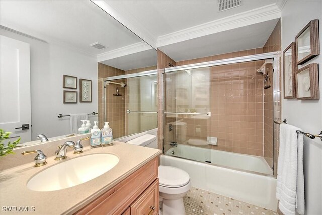 full bathroom with shower / bath combination with glass door, crown molding, vanity, and toilet