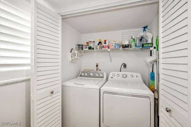 clothes washing area with washing machine and clothes dryer