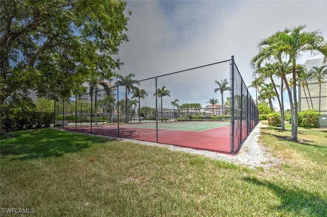 view of basketball court with a yard and tennis court