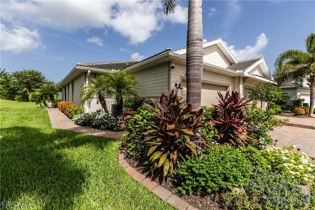 view of property exterior with a yard and a garage