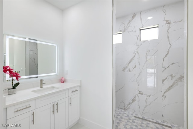 bathroom with vanity and tiled shower