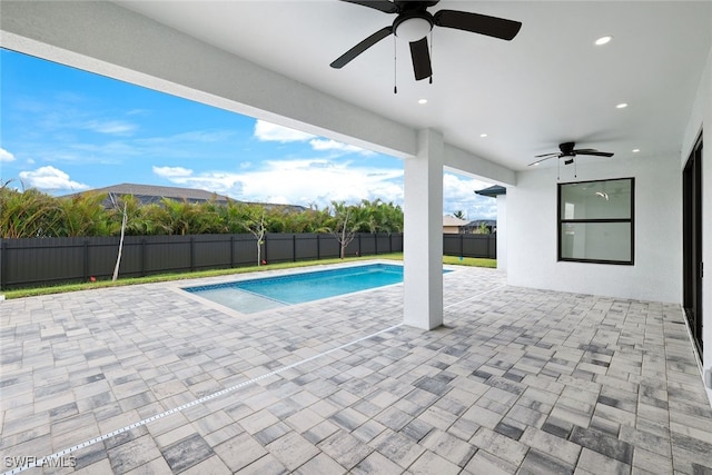 view of swimming pool with a patio area, a mountain view, and ceiling fan