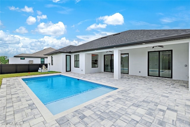 view of swimming pool featuring ceiling fan and a patio area