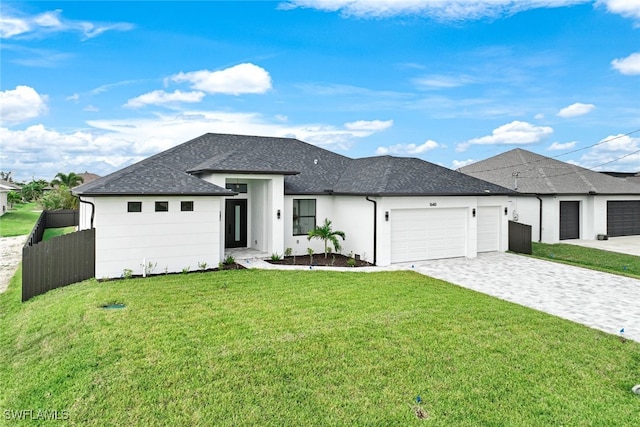 view of front of property with a garage and a front lawn