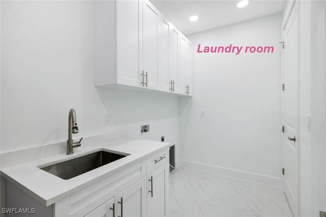 washroom with cabinets, sink, washer hookup, and hookup for an electric dryer