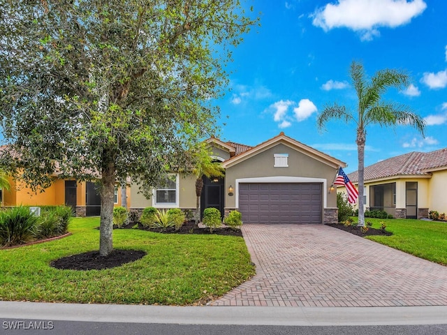 view of front of house with a front yard and a garage