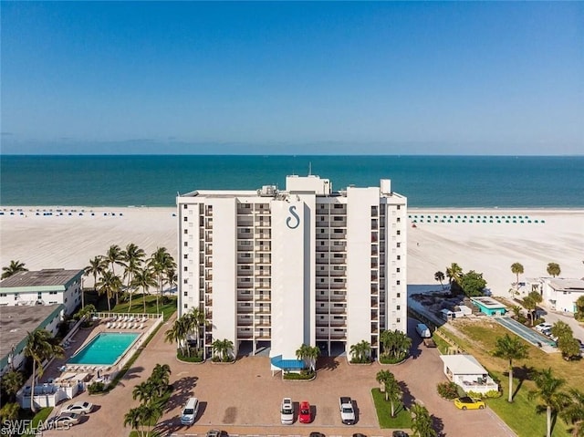 drone / aerial view featuring a water view and a view of the beach