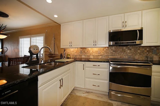 kitchen with sink, white cabinets, dark stone counters, and appliances with stainless steel finishes