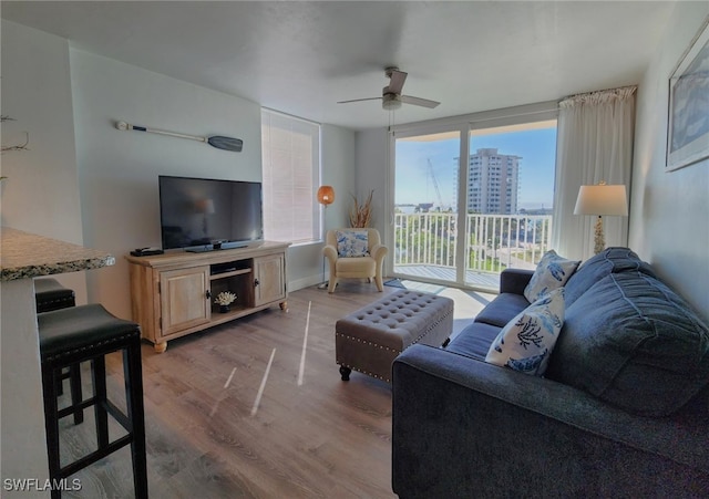 living room featuring light wood-type flooring and ceiling fan