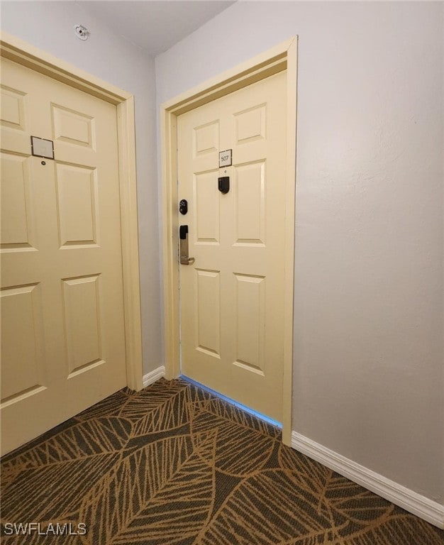 doorway with dark carpet