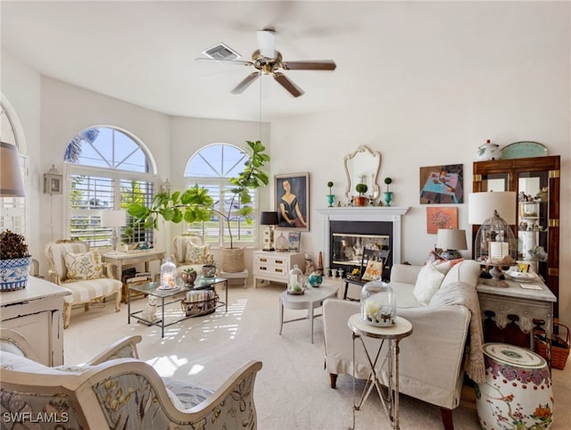 carpeted living room with ceiling fan