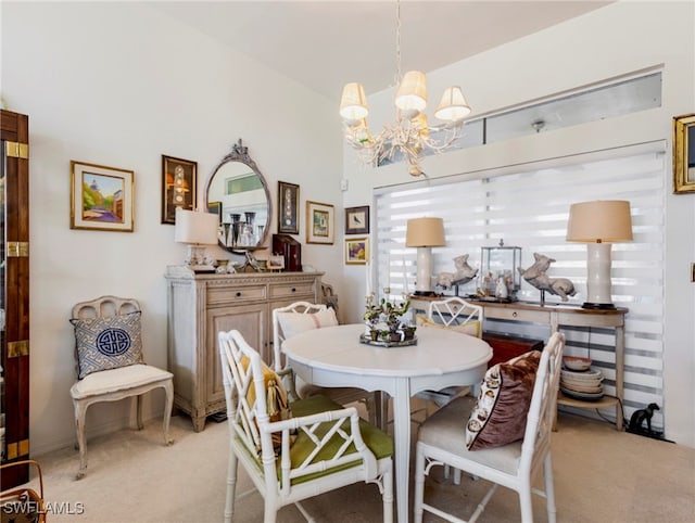 dining area featuring light colored carpet and an inviting chandelier