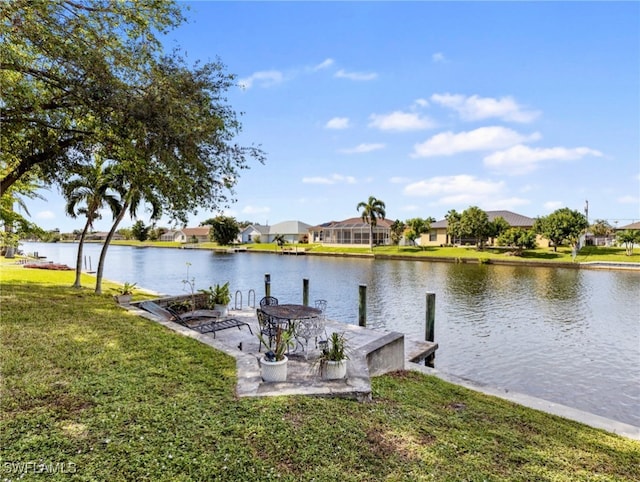 dock area featuring a lawn and a water view