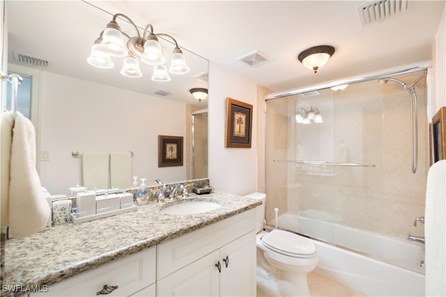 full bathroom featuring vanity, bath / shower combo with glass door, and toilet