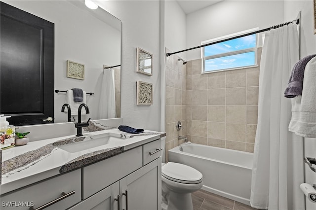 full bathroom featuring shower / bathtub combination with curtain, vanity, and toilet