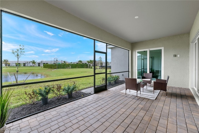 sunroom / solarium with a water view