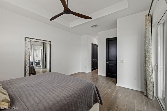 bedroom with ceiling fan and dark wood-type flooring