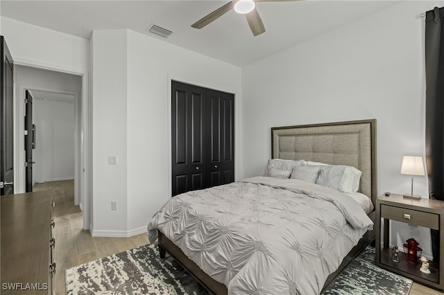 bedroom featuring light wood-type flooring, a closet, and ceiling fan