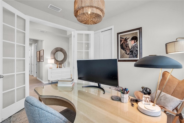 office space featuring french doors and hardwood / wood-style floors