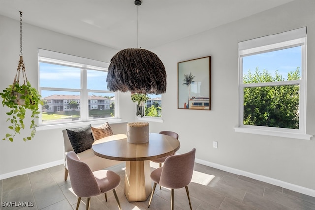 tiled dining space with a healthy amount of sunlight