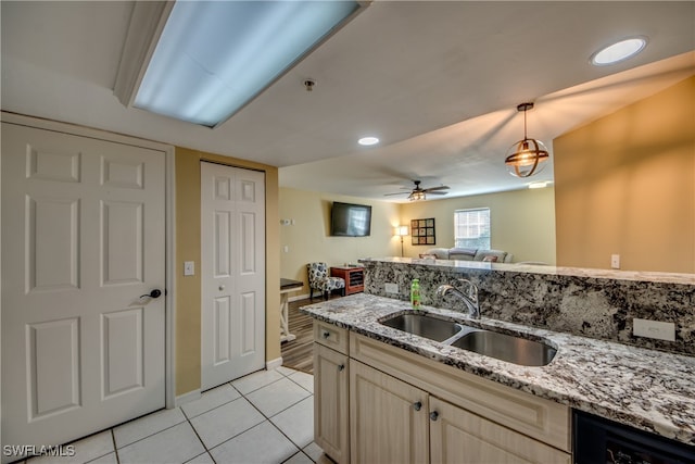 kitchen featuring dishwasher, sink, hanging light fixtures, ceiling fan, and light tile patterned flooring