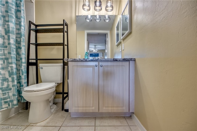 full bathroom with ceiling fan, tile patterned floors, toilet, shower / bath combo with shower curtain, and vanity