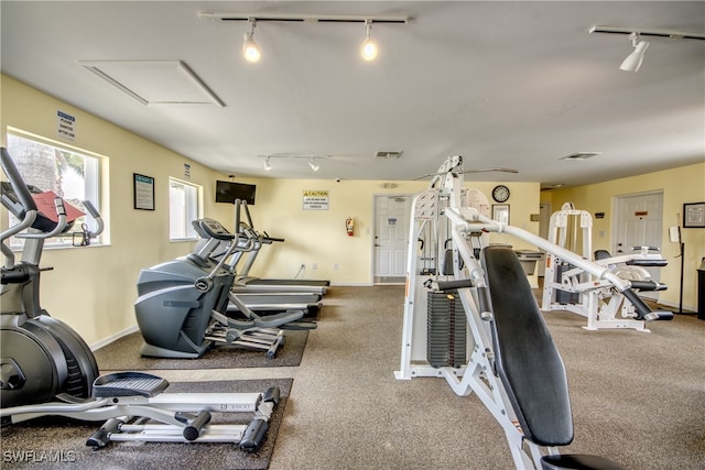 exercise room featuring rail lighting