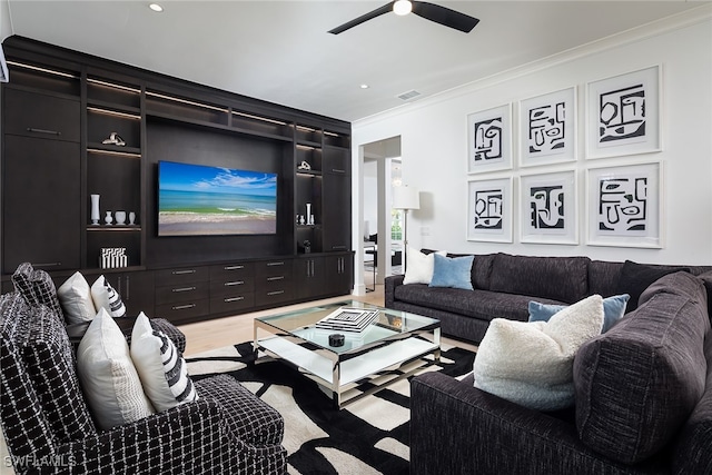 living room featuring crown molding, ceiling fan, and wood-type flooring