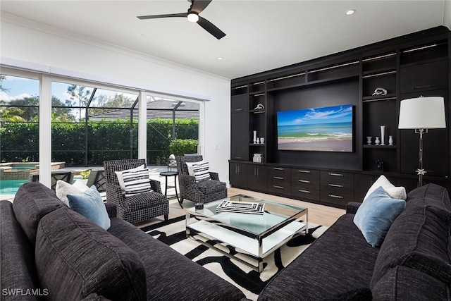 living room featuring crown molding, light hardwood / wood-style flooring, and ceiling fan