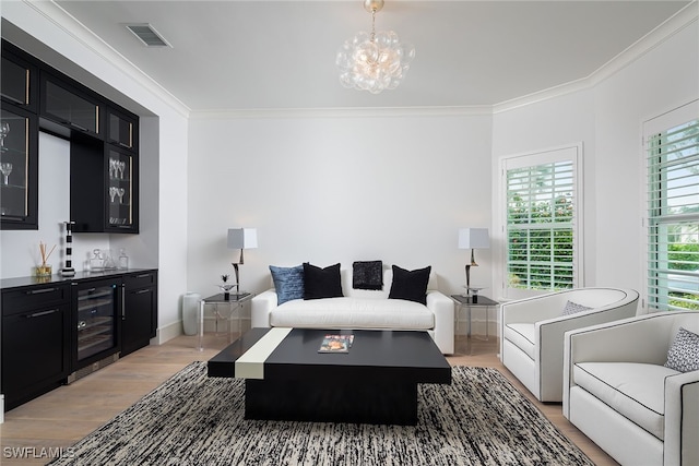 living room with ornamental molding, light hardwood / wood-style flooring, beverage cooler, and bar area