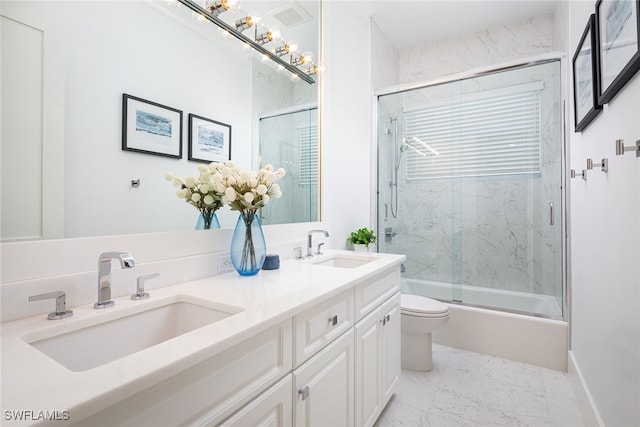 full bathroom featuring shower / bath combination with glass door, vanity, and toilet