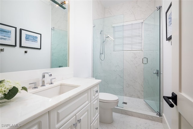 bathroom with vanity, toilet, and a shower with shower door