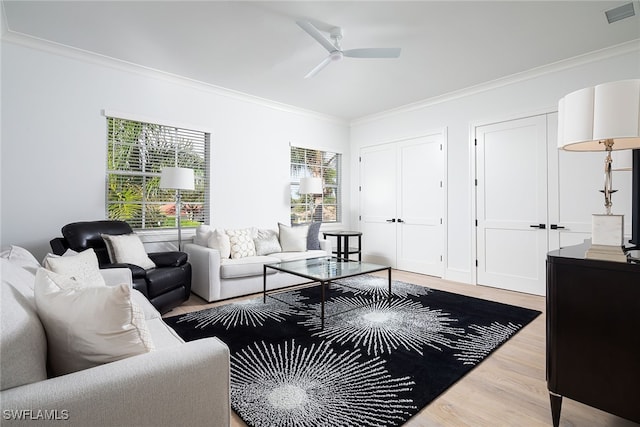 living room featuring ceiling fan, wood-type flooring, and ornamental molding