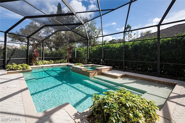 view of swimming pool featuring glass enclosure, an in ground hot tub, and a patio