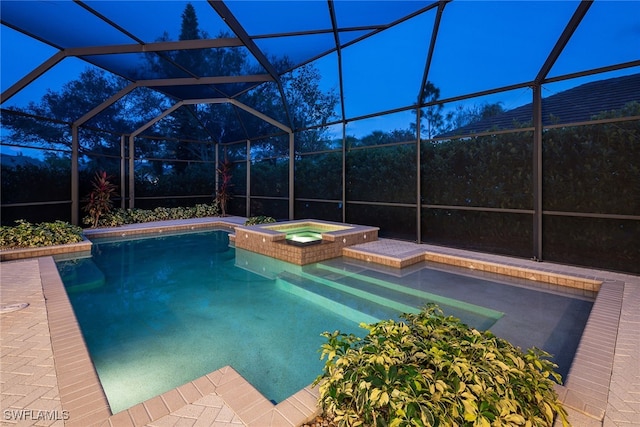 view of pool with glass enclosure and an in ground hot tub