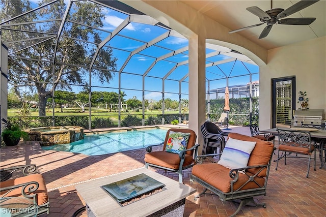 view of pool with glass enclosure, grilling area, ceiling fan, an in ground hot tub, and a patio area