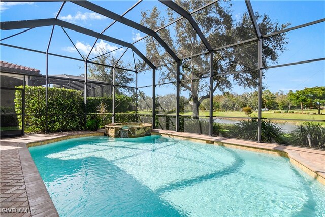 view of pool featuring a lanai and an in ground hot tub