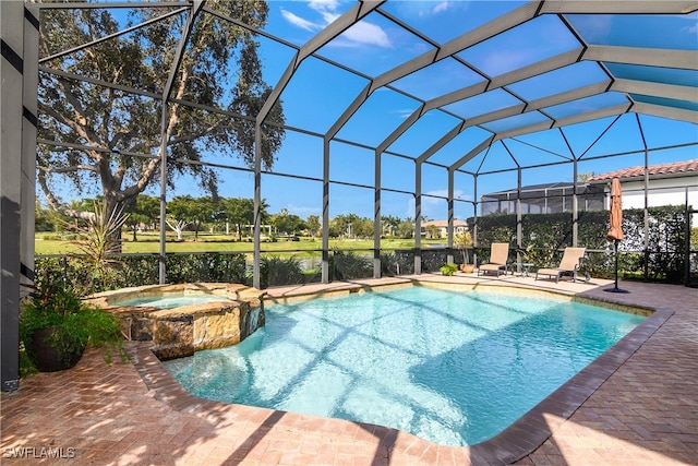 view of pool featuring a patio area, a lanai, and an in ground hot tub