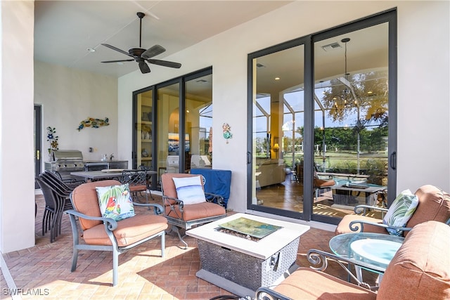 view of patio with a fire pit and ceiling fan