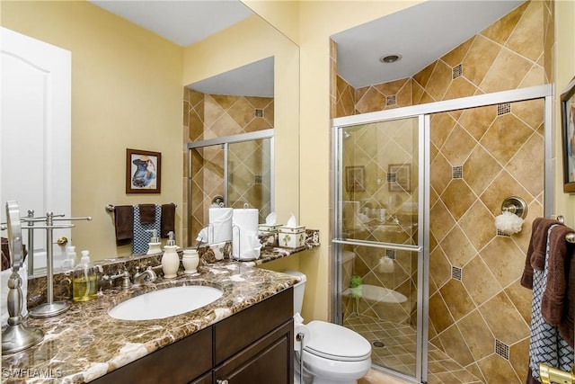 bathroom featuring vanity, toilet, and walk in shower