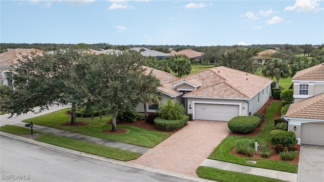 view of front of property featuring a front yard and a garage