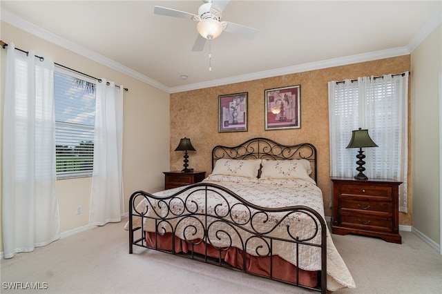 carpeted bedroom featuring ceiling fan and crown molding