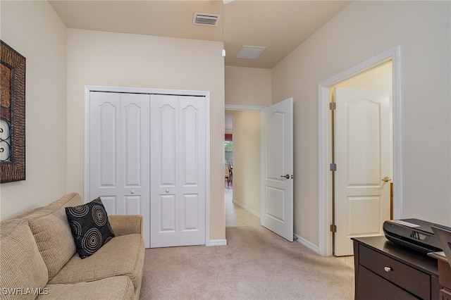 living area featuring light carpet