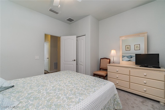 bedroom featuring light carpet, a closet, and ceiling fan