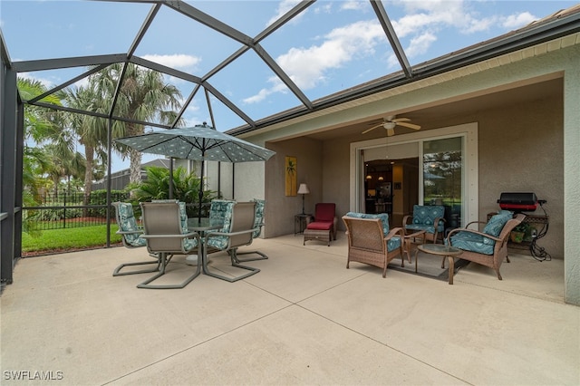 view of patio / terrace with ceiling fan and glass enclosure